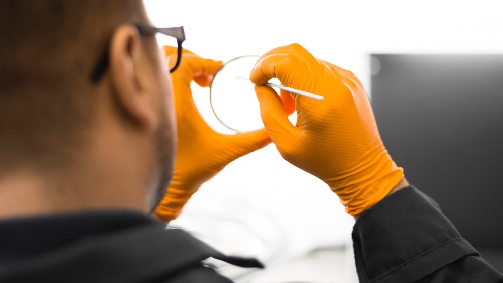 One of Allentown Optical's skilled Lab Technicians working with AR coating