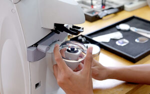 A person holding a microscope at Wholesale Optical Lab USA