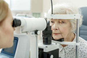 An older woman getting her eyes checked at an eye exam. Optics Suppliers Pennsylvania.